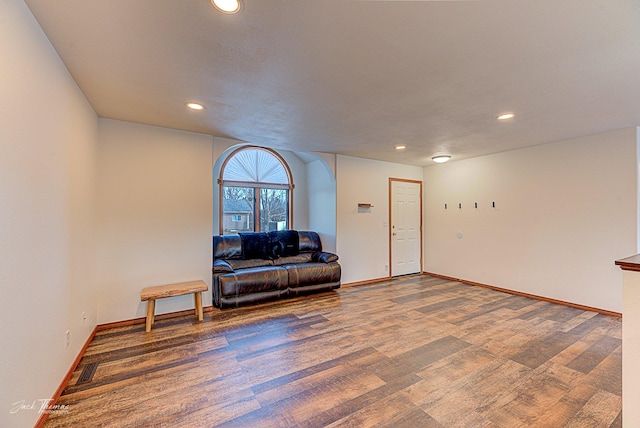 living area featuring baseboards, wood finished floors, and recessed lighting