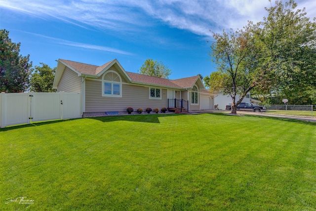 view of front of home featuring a garage, a gate, fence, and a front yard