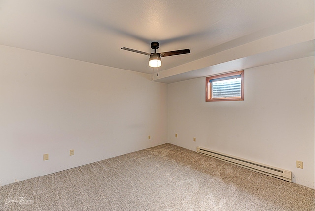 unfurnished room with a baseboard heating unit, carpet floors, and a ceiling fan