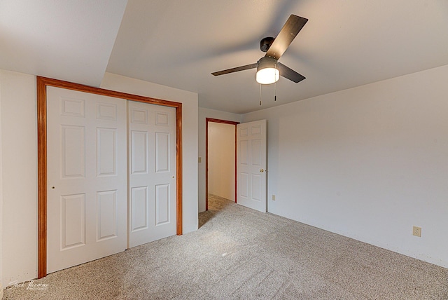 unfurnished bedroom featuring ceiling fan, a closet, and carpet