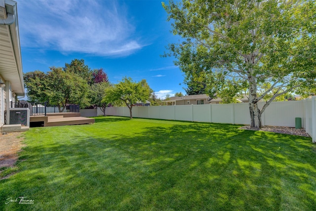 view of yard with a fenced backyard and a deck