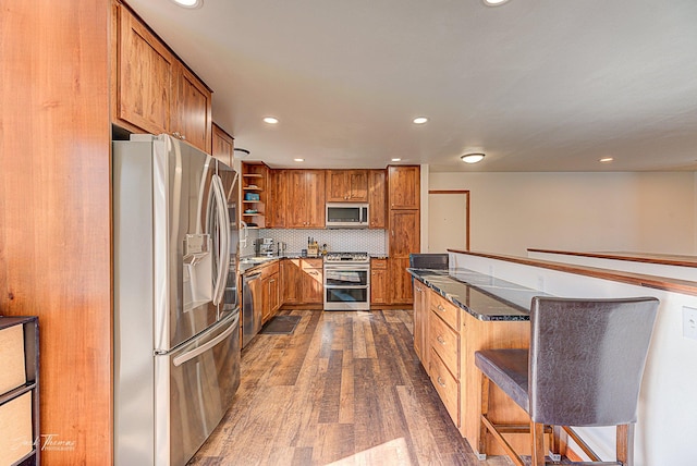 kitchen with dark wood-style floors, open shelves, backsplash, appliances with stainless steel finishes, and brown cabinetry