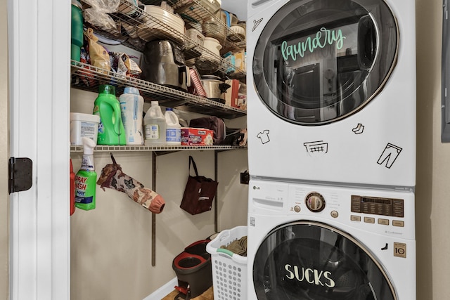 laundry area with stacked washer and clothes dryer and laundry area