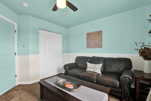 living room featuring carpet floors and a ceiling fan