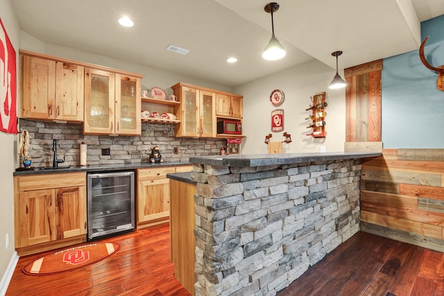 bar with wine cooler, visible vents, dark wood-type flooring, and indoor wet bar