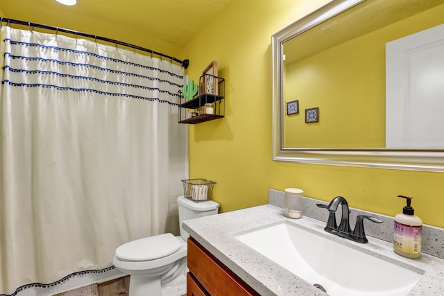 bathroom with toilet, curtained shower, and vanity