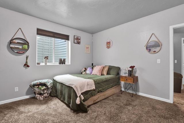 bedroom with carpet floors and baseboards