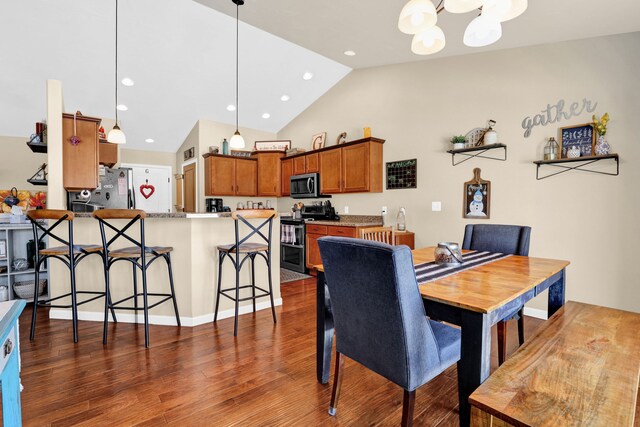 dining space with lofted ceiling, a chandelier, wood finished floors, and recessed lighting