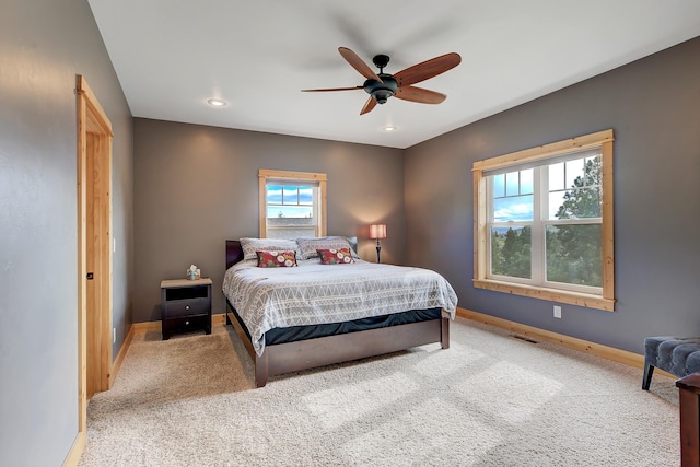 carpeted bedroom with a ceiling fan, recessed lighting, visible vents, and baseboards