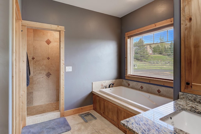 full bathroom featuring a sink, baseboards, a tile shower, a bath, and tile patterned floors