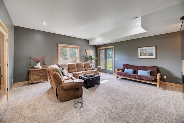 living area featuring light colored carpet, visible vents, baseboards, and recessed lighting