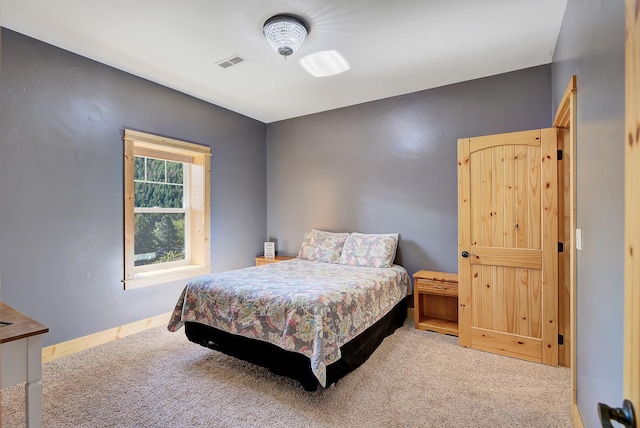 bedroom featuring carpet floors, baseboards, and visible vents