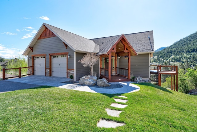 rustic home featuring a garage, driveway, a front lawn, and a shingled roof