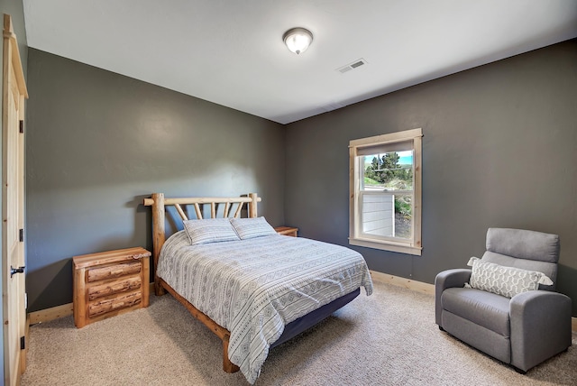 carpeted bedroom featuring baseboards and visible vents