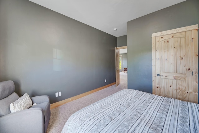 carpeted bedroom featuring baseboards