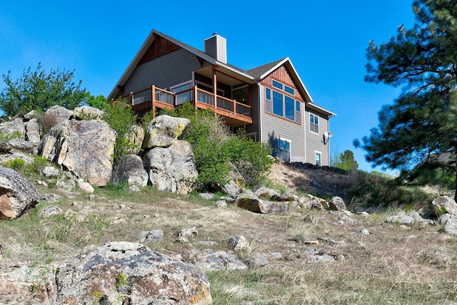 back of property with a chimney