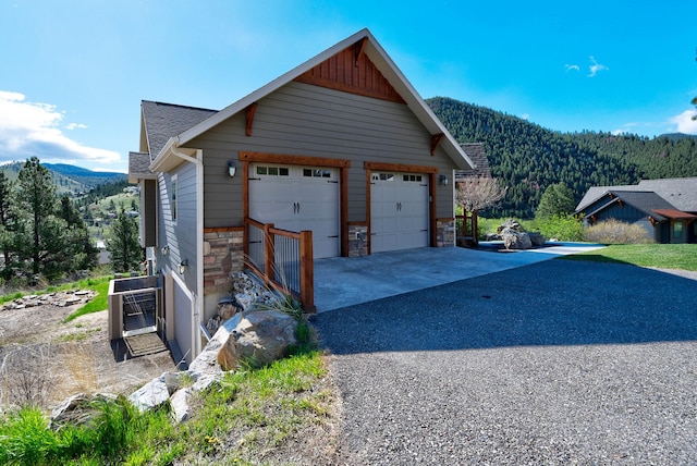 detached garage with a forest view and a mountain view