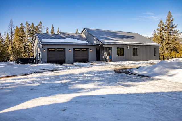 view of front of home with metal roof and an attached garage