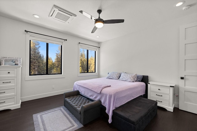 bedroom with visible vents, baseboards, dark wood-type flooring, and recessed lighting