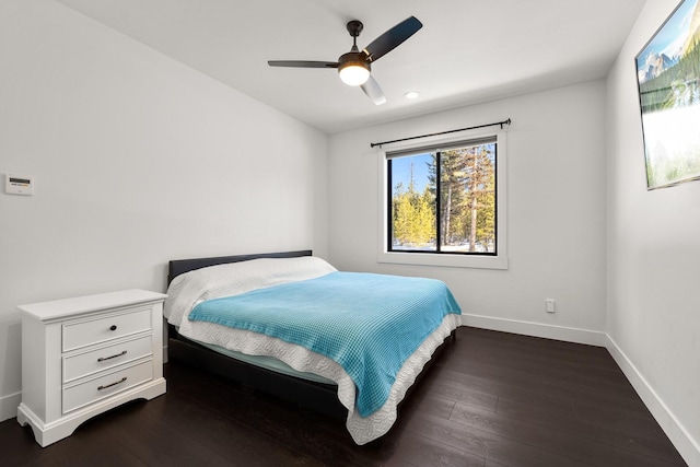 bedroom featuring dark wood-style floors, baseboards, and a ceiling fan