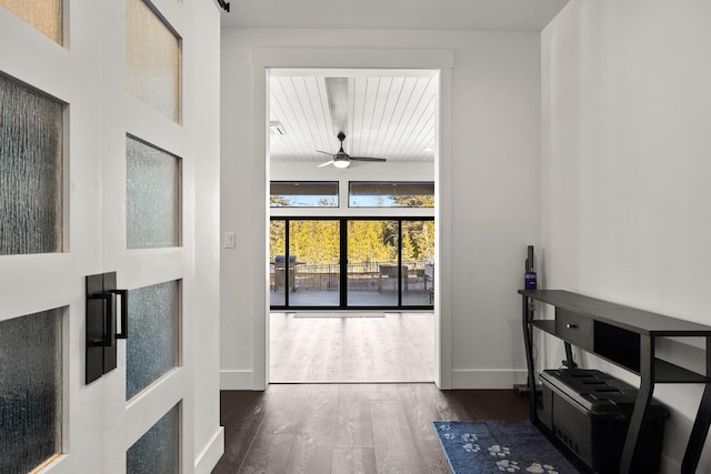 entryway featuring ceiling fan, baseboards, and wood finished floors