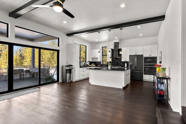 kitchen featuring backsplash, range hood, dark wood-style floors, black appliances, and dark countertops