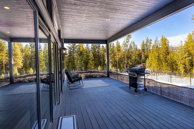 wooden terrace with fence and area for grilling