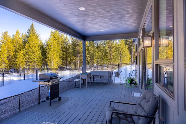 deck featuring grilling area and fence