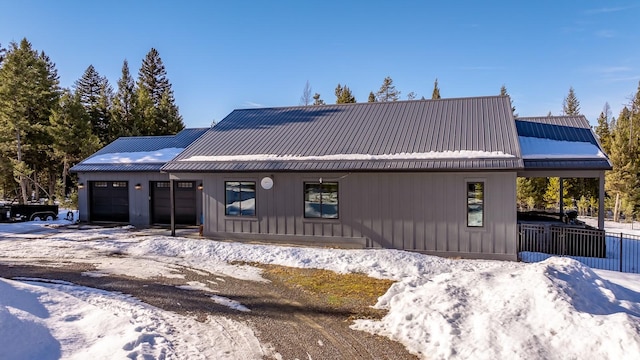 view of front facade featuring a garage and metal roof