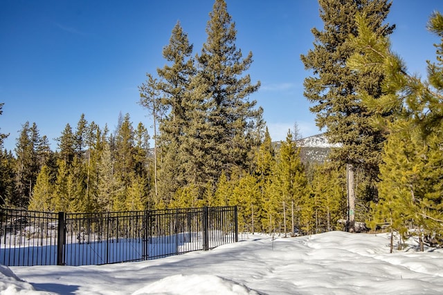 exterior space featuring fence and a forest view