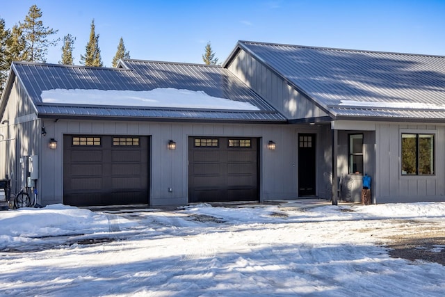 modern farmhouse style home with an attached garage, metal roof, and board and batten siding