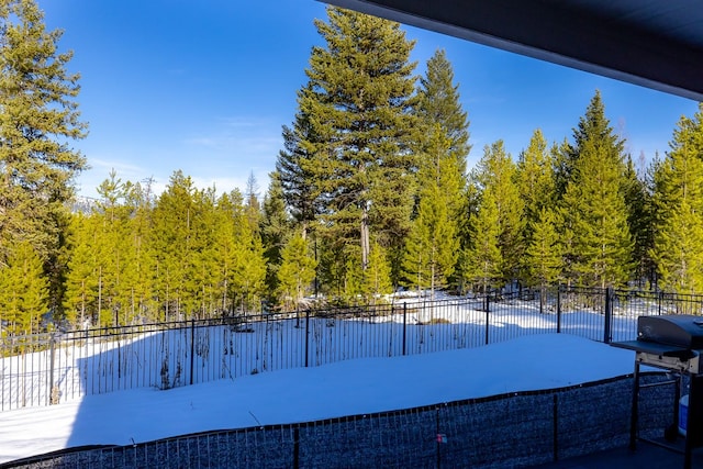 exterior space featuring grilling area and fence