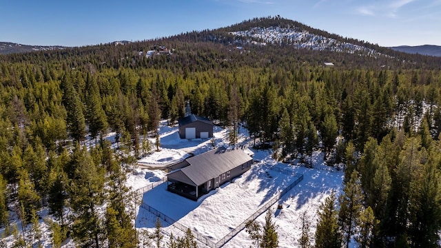 birds eye view of property with a mountain view and a forest view