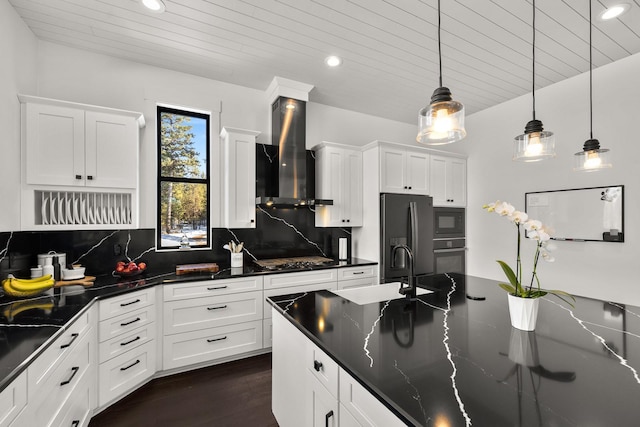 kitchen featuring black microwave, a sink, refrigerator with ice dispenser, decorative backsplash, and wall chimney exhaust hood