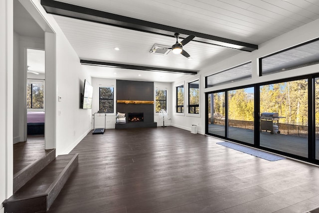 unfurnished living room with baseboards, a ceiling fan, dark wood-style flooring, beamed ceiling, and a fireplace