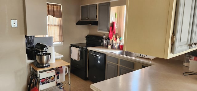 kitchen with black appliances, ventilation hood, and light countertops