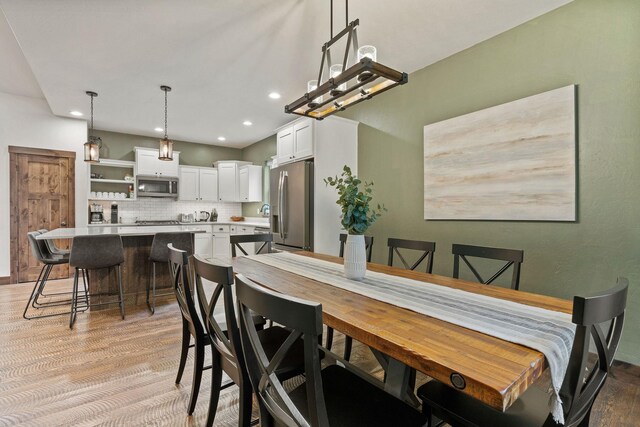 230 Forest Edge Trl, Kalispell, MT 59901 - bedroom featuring visible vents, lofted ceiling, wood finished floors, baseboards, and recessed lighting