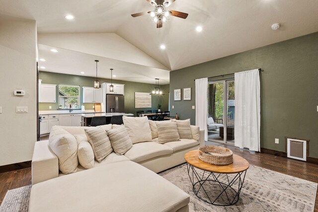 230 Forest Edge Trl, Kalispell, MT 59901 - living room with ceiling fan, a stone fireplace, baseboards, wood finished floors, and lofted ceiling