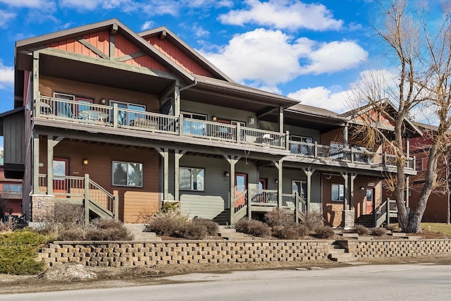 view of front of house featuring a porch, board and batten siding, and stairs