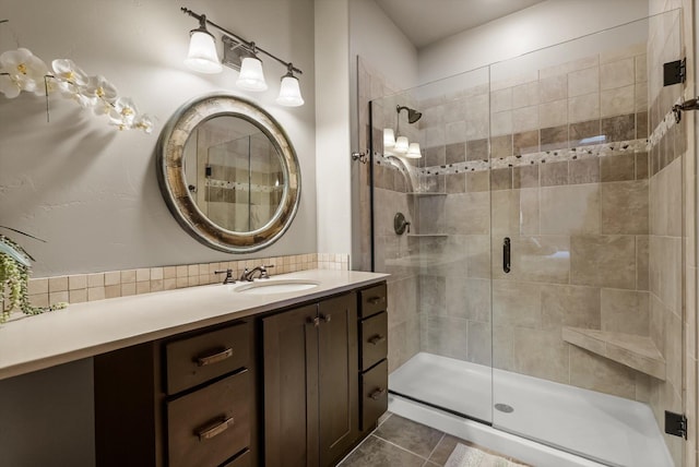 bathroom with a stall shower, vanity, and tile patterned floors