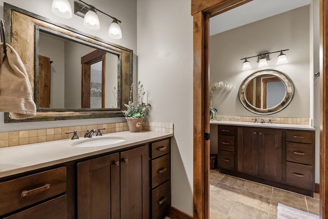 bathroom featuring a sink, backsplash, and two vanities