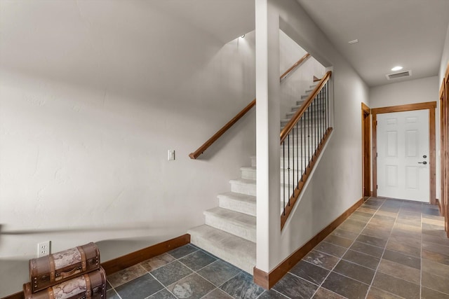 stairs featuring recessed lighting, stone finish flooring, visible vents, and baseboards