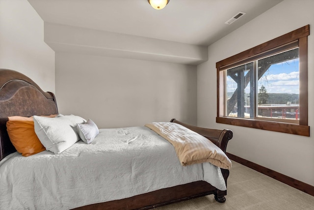 carpeted bedroom featuring baseboards and visible vents