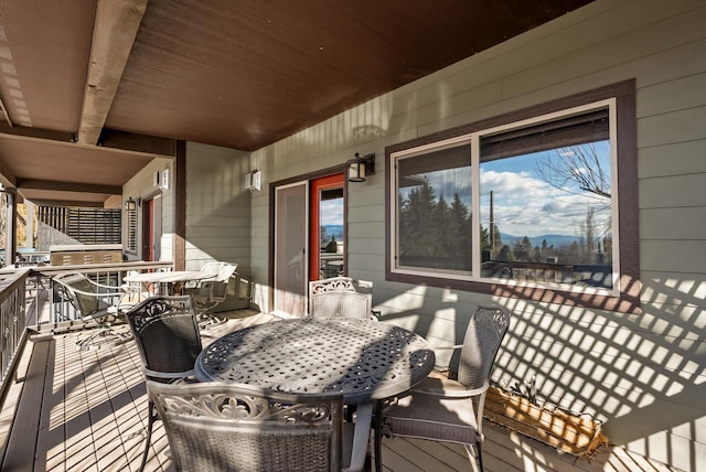 wooden terrace featuring outdoor dining area