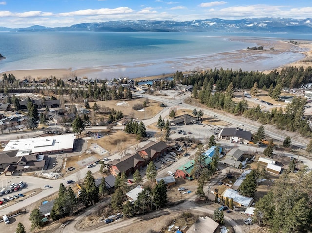 drone / aerial view featuring a beach view and a water and mountain view