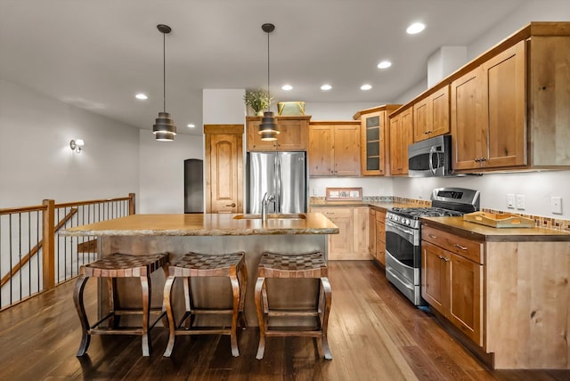 kitchen featuring stainless steel appliances, dark wood finished floors, glass insert cabinets, and recessed lighting