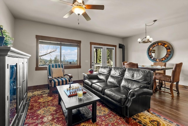 living room with dark wood-style floors, plenty of natural light, baseboards, and french doors