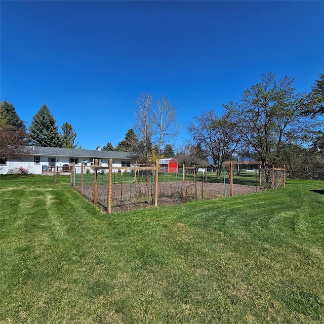 view of yard with fence and a garden