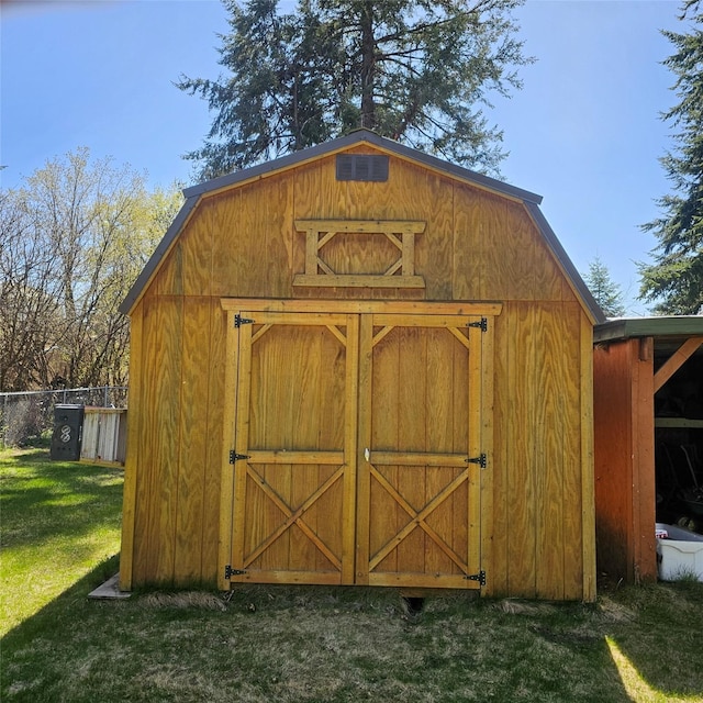 view of shed featuring fence