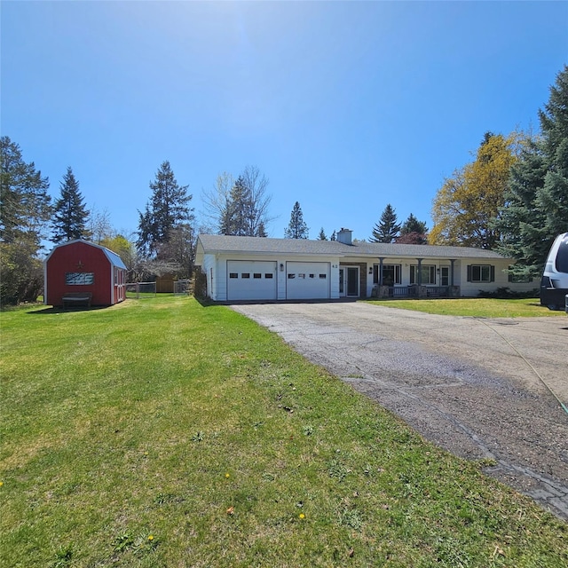ranch-style home featuring a porch, aphalt driveway, a garage, a front lawn, and a chimney